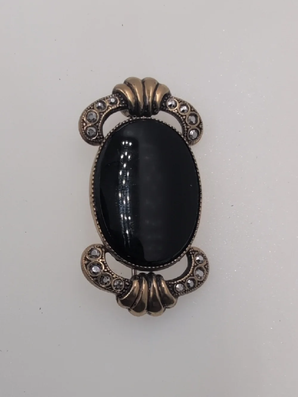 Gold-Tone Black Oval Cabochon Brooch with Crystal Accents